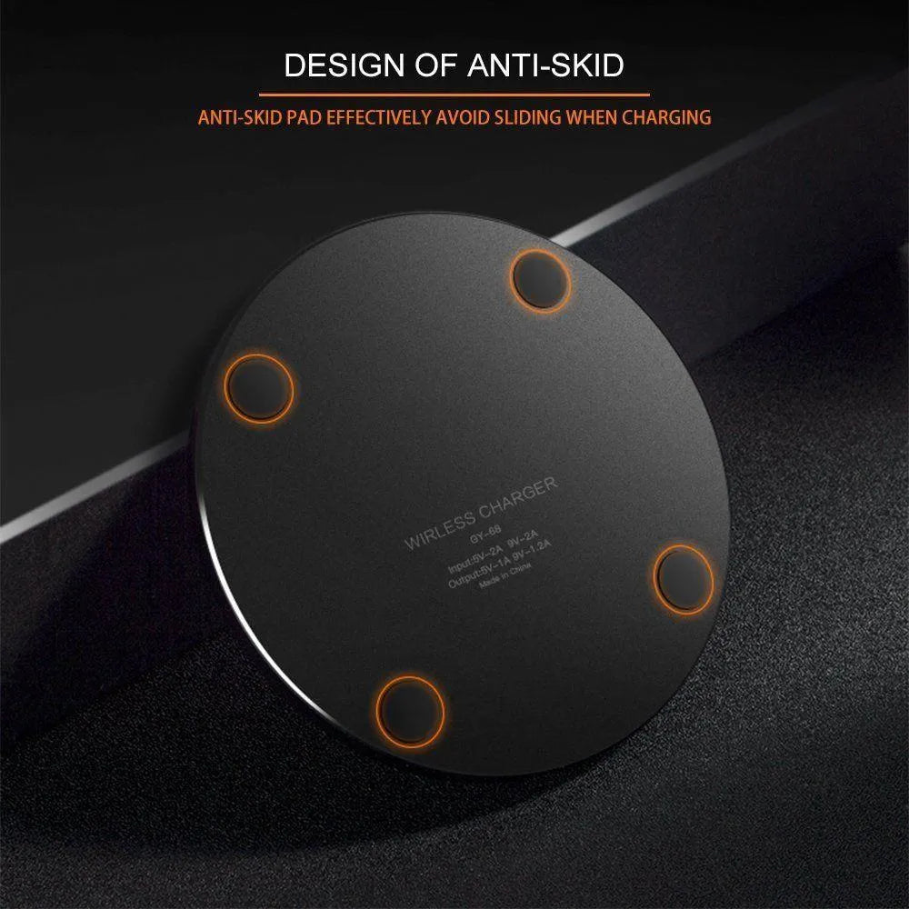 Black ultra-thin square wireless fast charging pad with USB cable on a desk