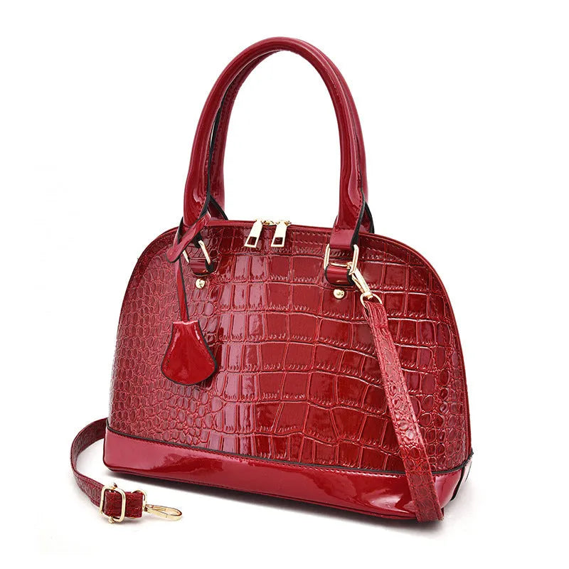 Shiny black PU leather shell-shaped crossbody bag showing its structured design and size.