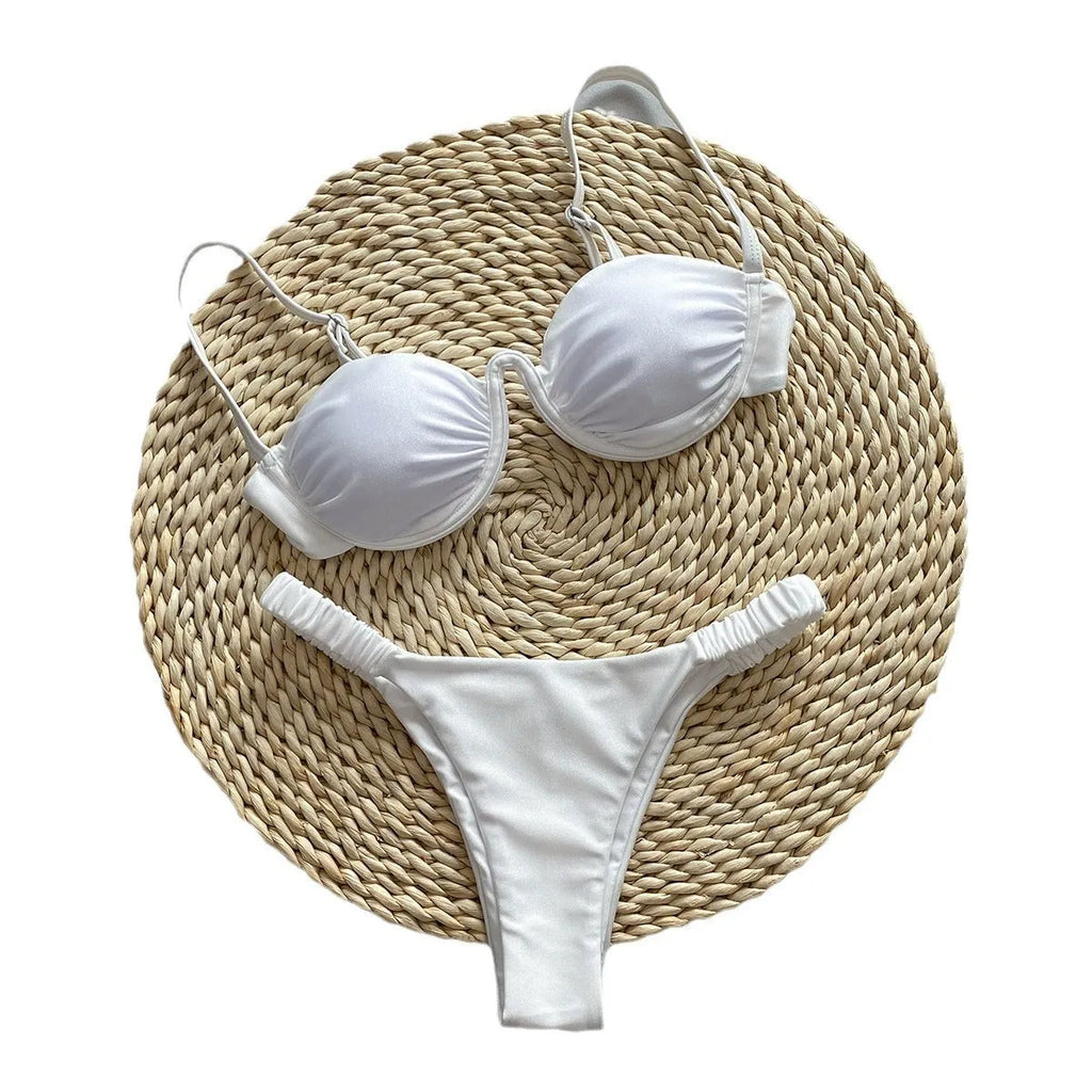 Women's black underwire bikini top and briefs set on a mannequin, showing sleeveless design.