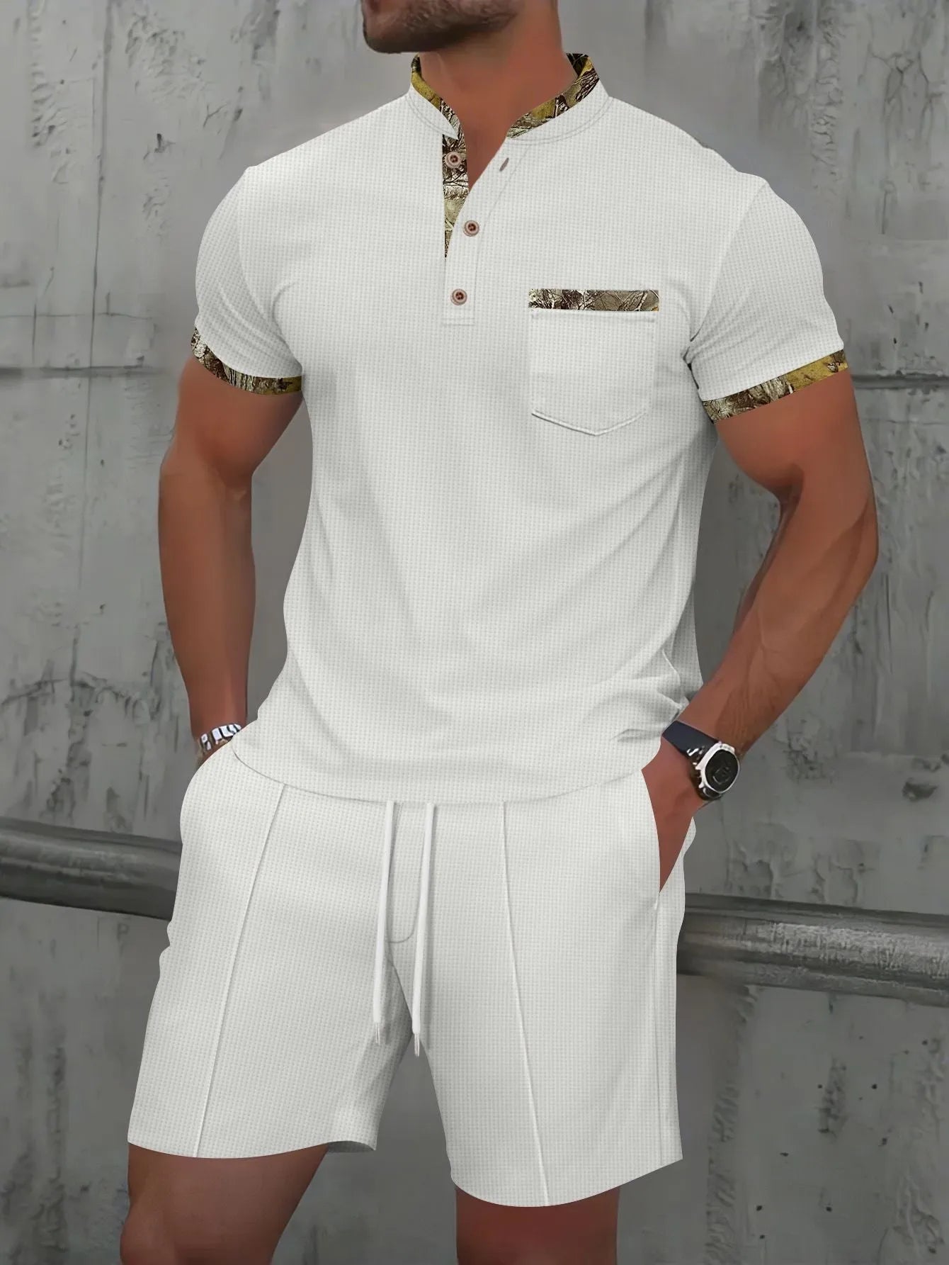 Man wearing a grey waffle knit zip-up polo collar tracksuit with matching shorts for summer leisure.