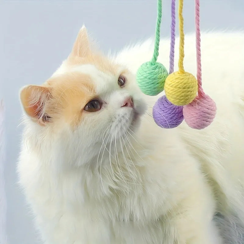 Interactive cat toy ball with rope attachment and built-in bell in green, pink, purple and yellow colours