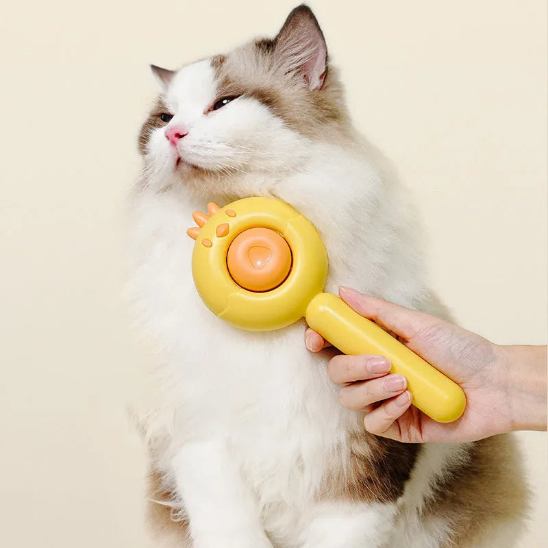 Purple pet grooming brush with stainless steel bristles and a one-button self-cleaning mechanism on a white background.