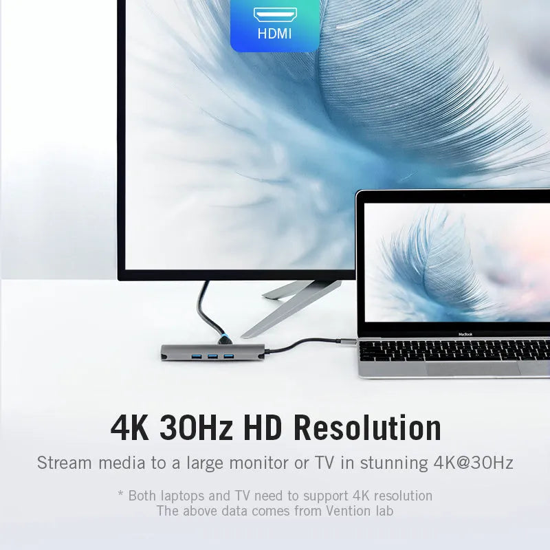 Deep grey USB-C multi-port hub showing HDMI, USB, Ethernet, and card reader ports on a compact rectangular body.