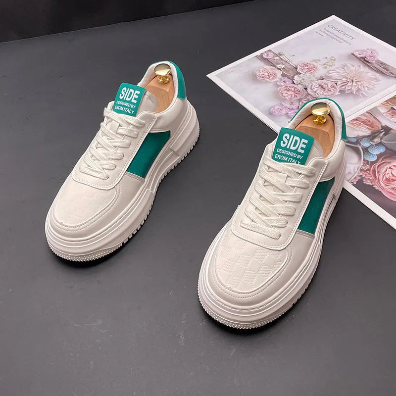 White and green sports casual shoes with cloth upper and rubber foam sole on a plain background.