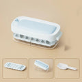 Yellow lever-operated ice cube tray grid with high capacity design and stored ice shovel.