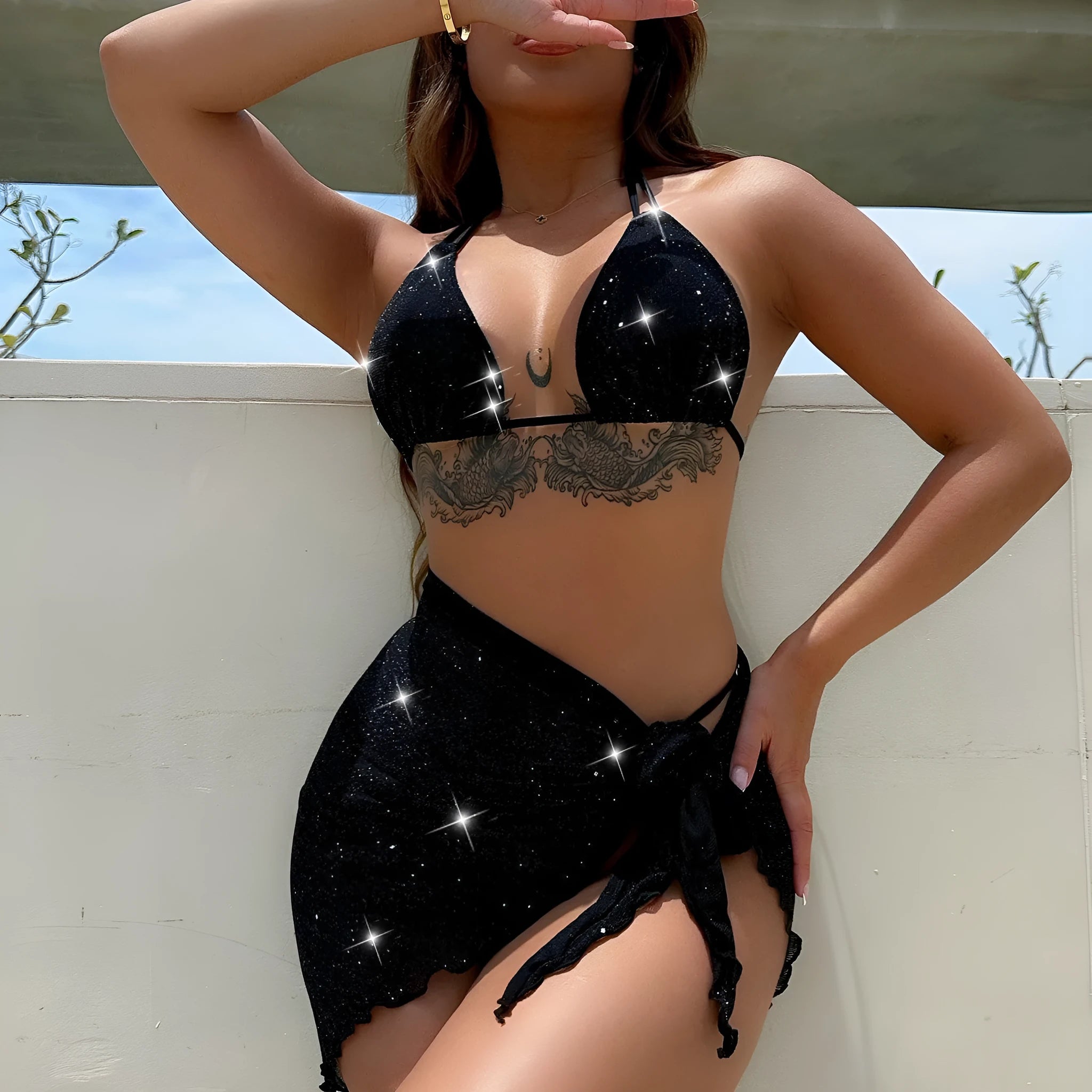 Black three-piece bikini swimsuit set with crop top and shorts on a mannequin.