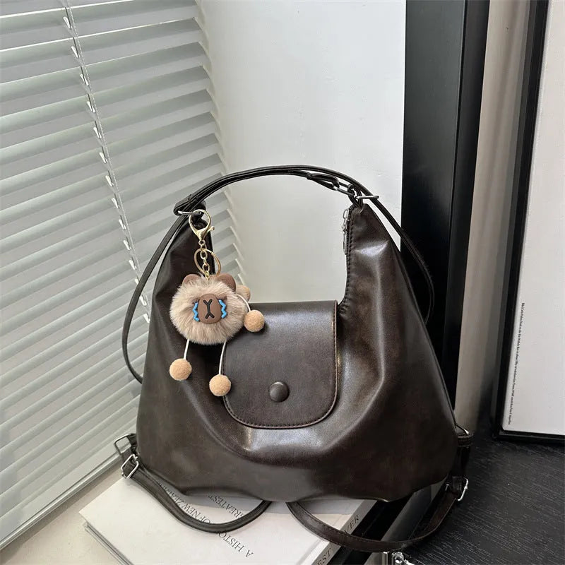 Women's black PU leather horizontal square shoulder bag with single strap and internal phone pocket