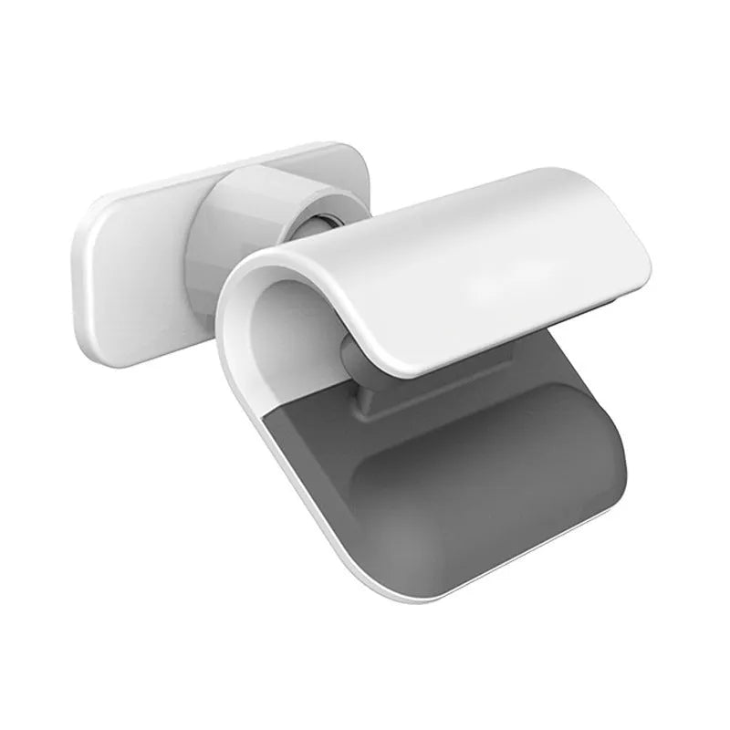 Black universal gravity car phone holder with 360-degree rotating head on a car dashboard.