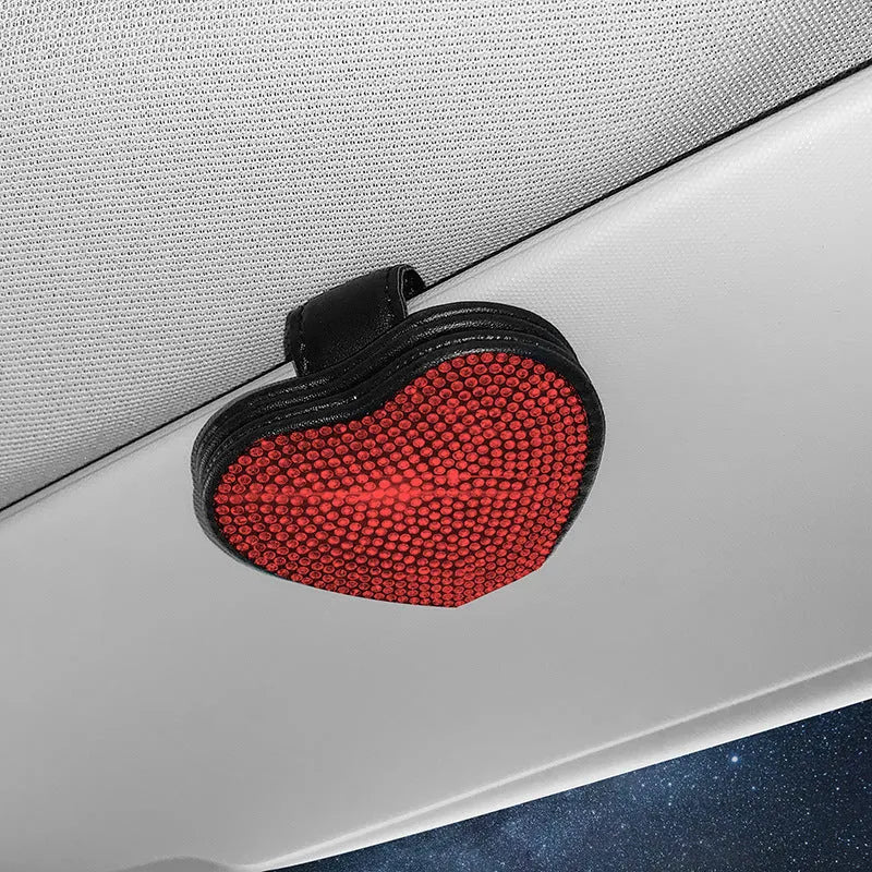 Black diamond-encrusted PU leather magnetic storage clip for car sun visor, holding sunglasses.