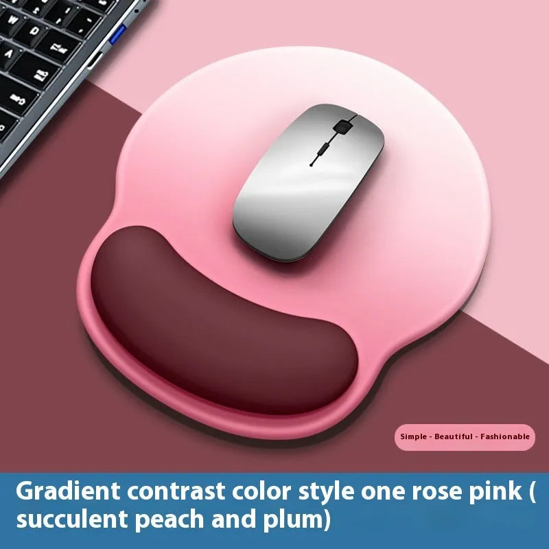 Silicone mouse mat with attached gel wrist support in a gradient blue colour on a desk.