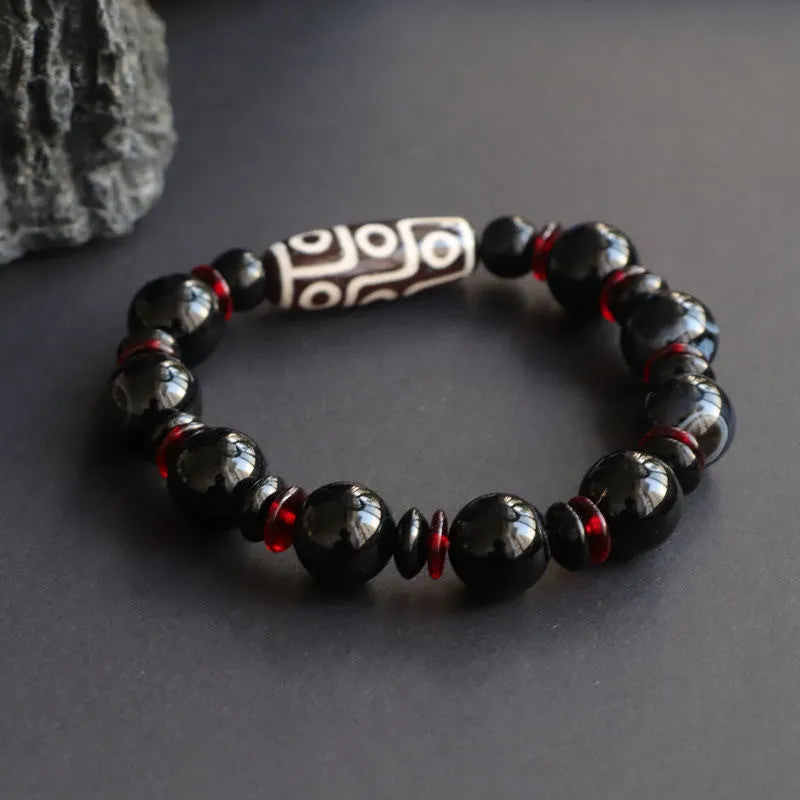 Black agate Dzi bead bracelet with geometric 11mm beads on wrist