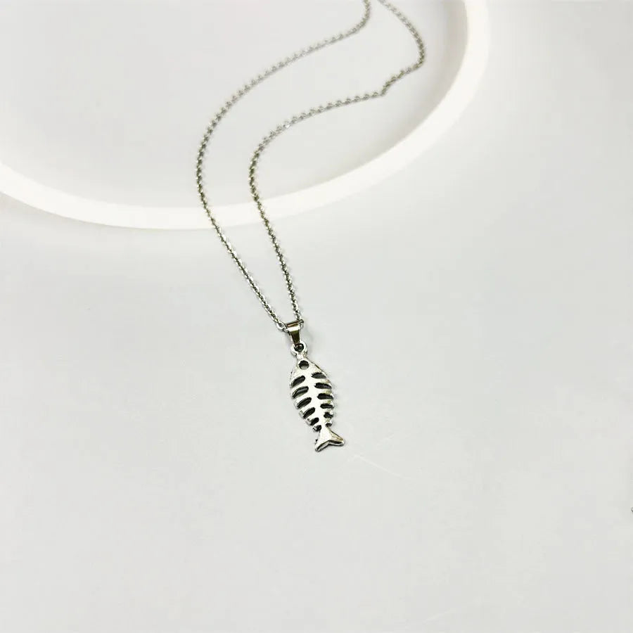 Fishbone pendant necklace and earrings set with adjustable chain on white background