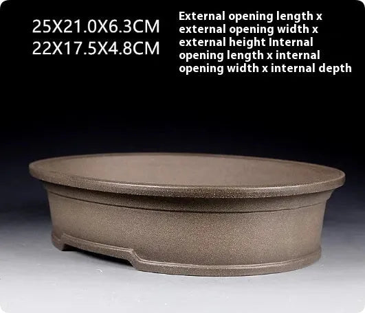 Handmade antique oval purple sand ceramic bonsai pot on a surface.