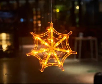 Set of seven battery-powered Halloween LED hanging lights with ghost, spider, and pumpkin designs for window decoration.