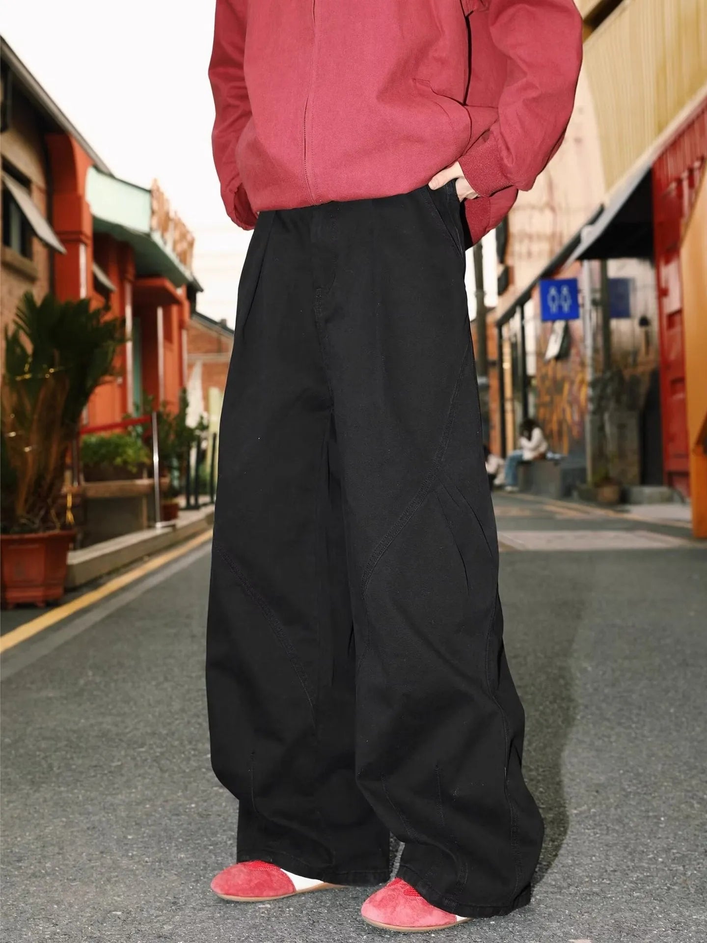 Men's pleated straight-leg trousers in apricot colour showing elasticated waistband detail.