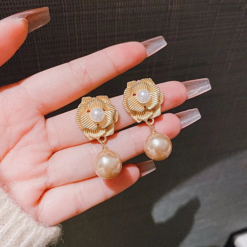 Gold-toned stud earrings with Hong Kong style ice flower design and centre opal stone