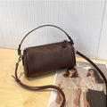 Soft genuine leather cylindrical crossbody phone bag in street style with sewing thread detailing