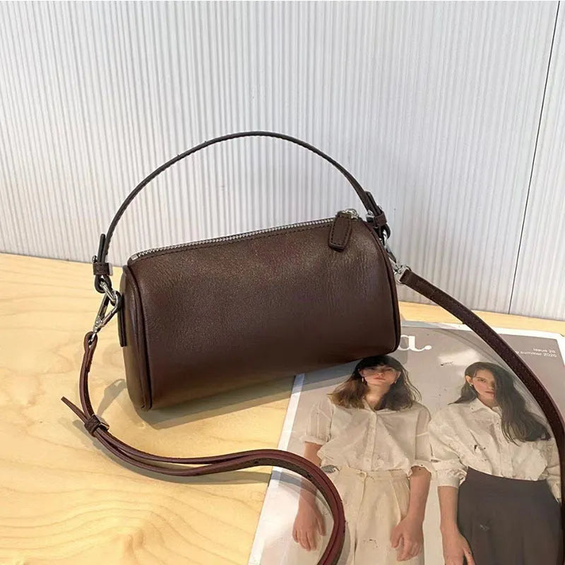 Soft genuine leather cylindrical crossbody phone bag in street style with sewing thread detailing