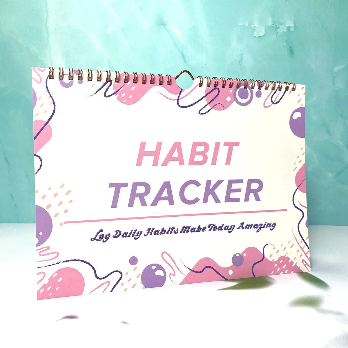 Habit tracking device showing 12 internal pages for schedule planning in various colour options