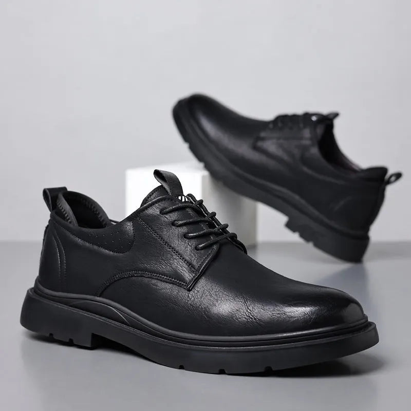 Men's black and brown leather casual sneakers with sewing line detail on the upper.