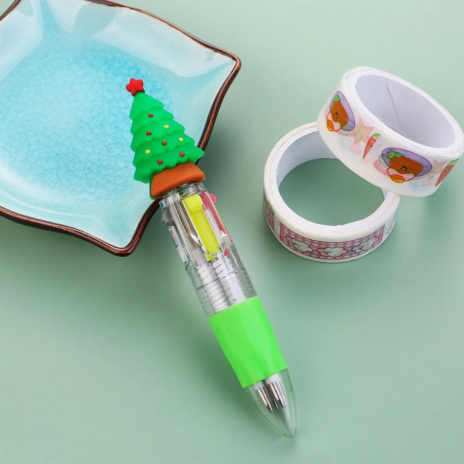 Compact 11cm Christmas four-colour press pen with festive designs including reindeer and snowmen.