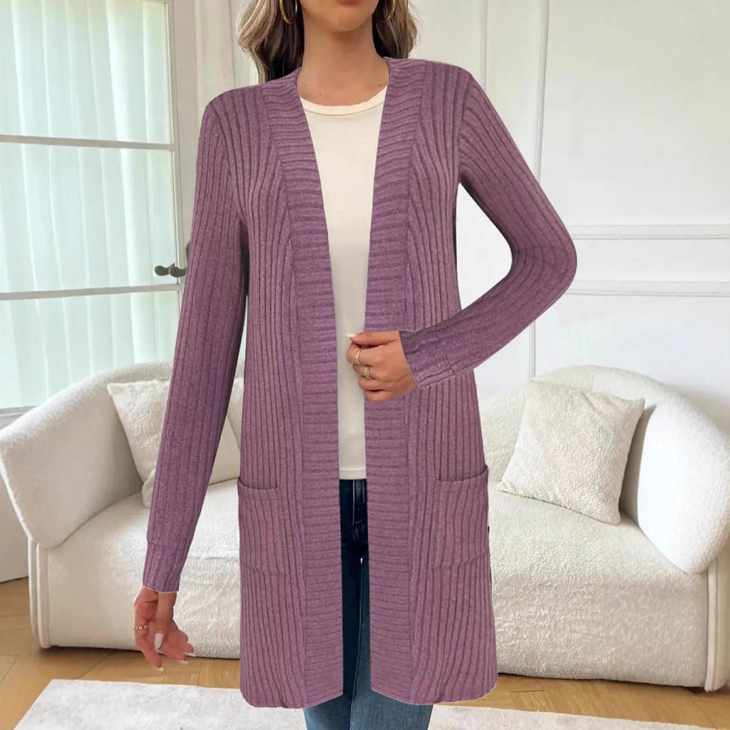 Long sleeve loose fit knitted cardigan jacket in black, shown with two front pockets.