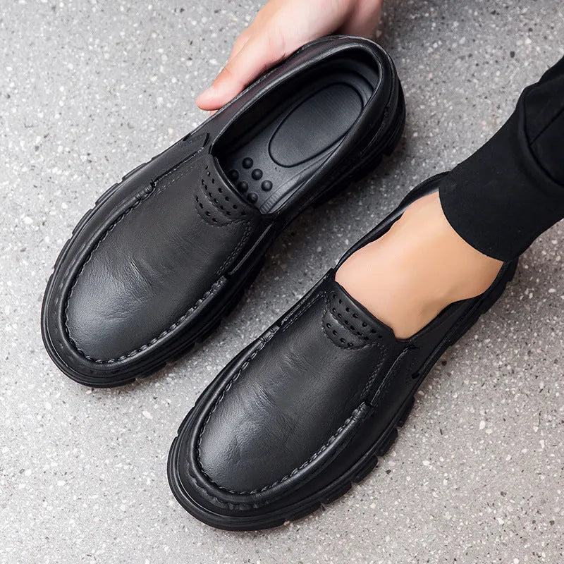 Men's black slip-on platform shoes with round toe and mid-top design on a white background.