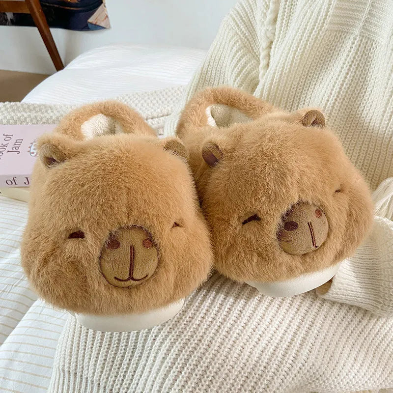 Light brown women's plush winter slippers with a round toe and slip-on design on a white background.