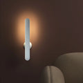 Geometric desk lamp with magnetic base shown attached to metal surface as wall light