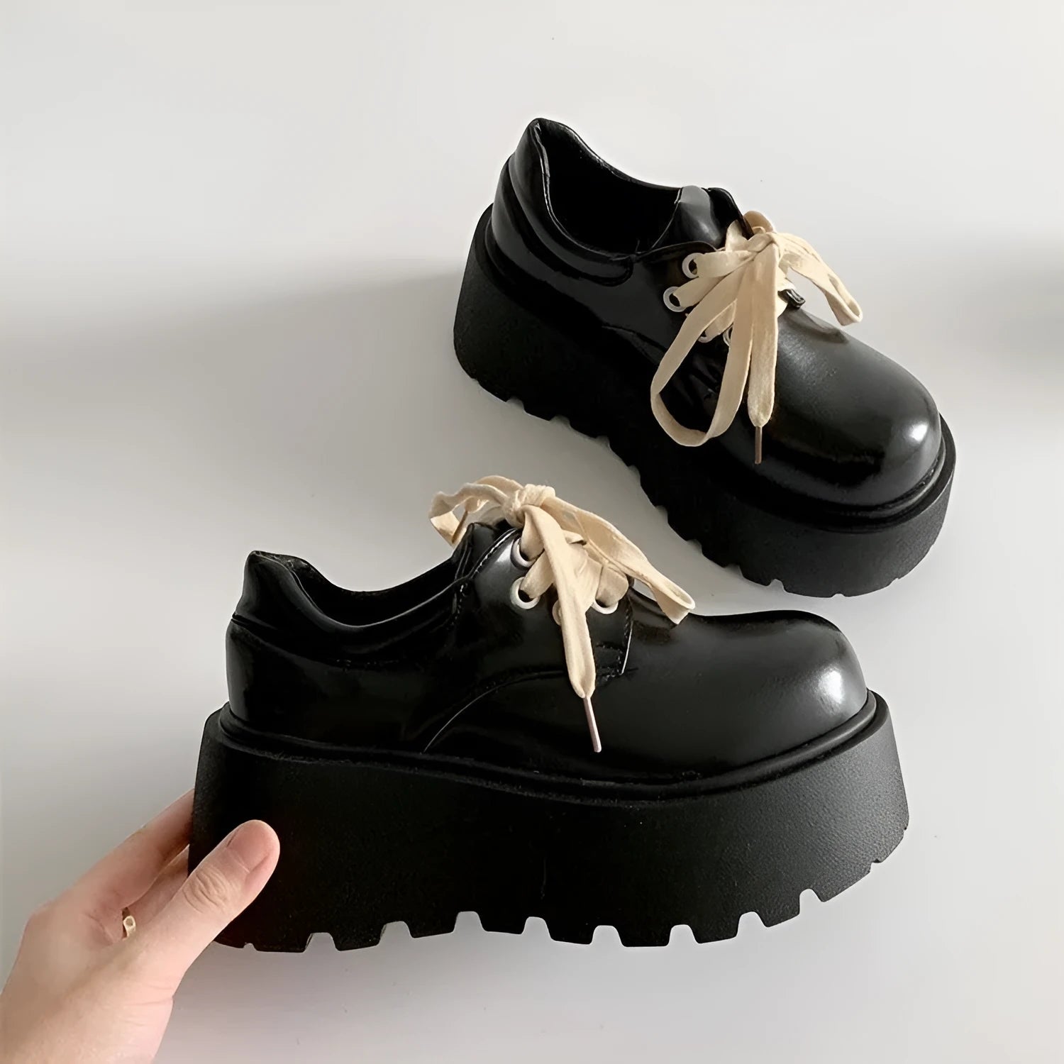 Women's matte black lace-up ankle boots with a thick rubber sole and a chunky heel on a white background.