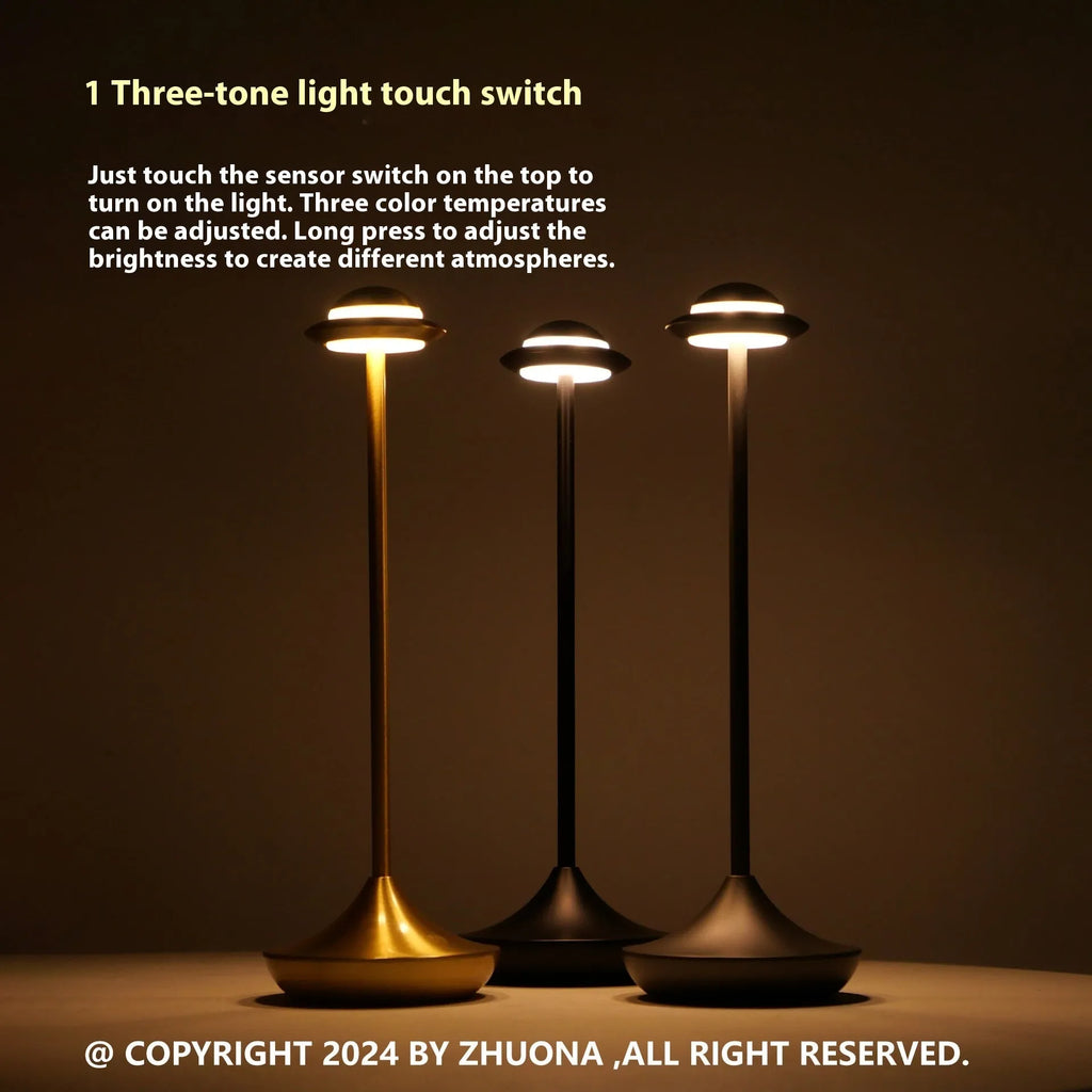 UFO-shaped table lamp with metallic finish and touch controls on desk surface