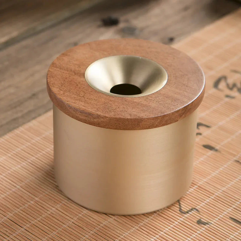 Brass ashtray with a wooden lid featuring a central hole, shown in black wood and red wood options.