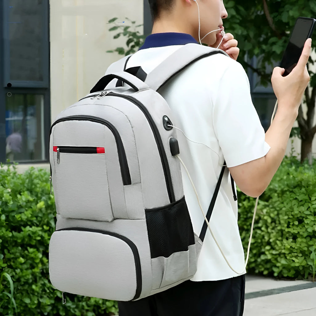 Light grey insulated oxford cloth backpack with curved shoulder straps and front compartments.