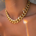 Women's gold electroplated thick chain necklace showing 32cm length and alloy construction