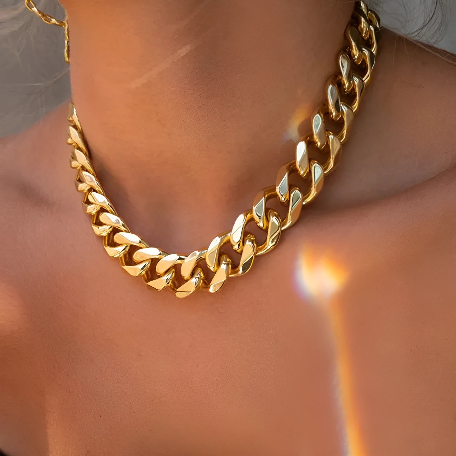 Women's gold electroplated thick chain necklace showing 32cm length and alloy construction