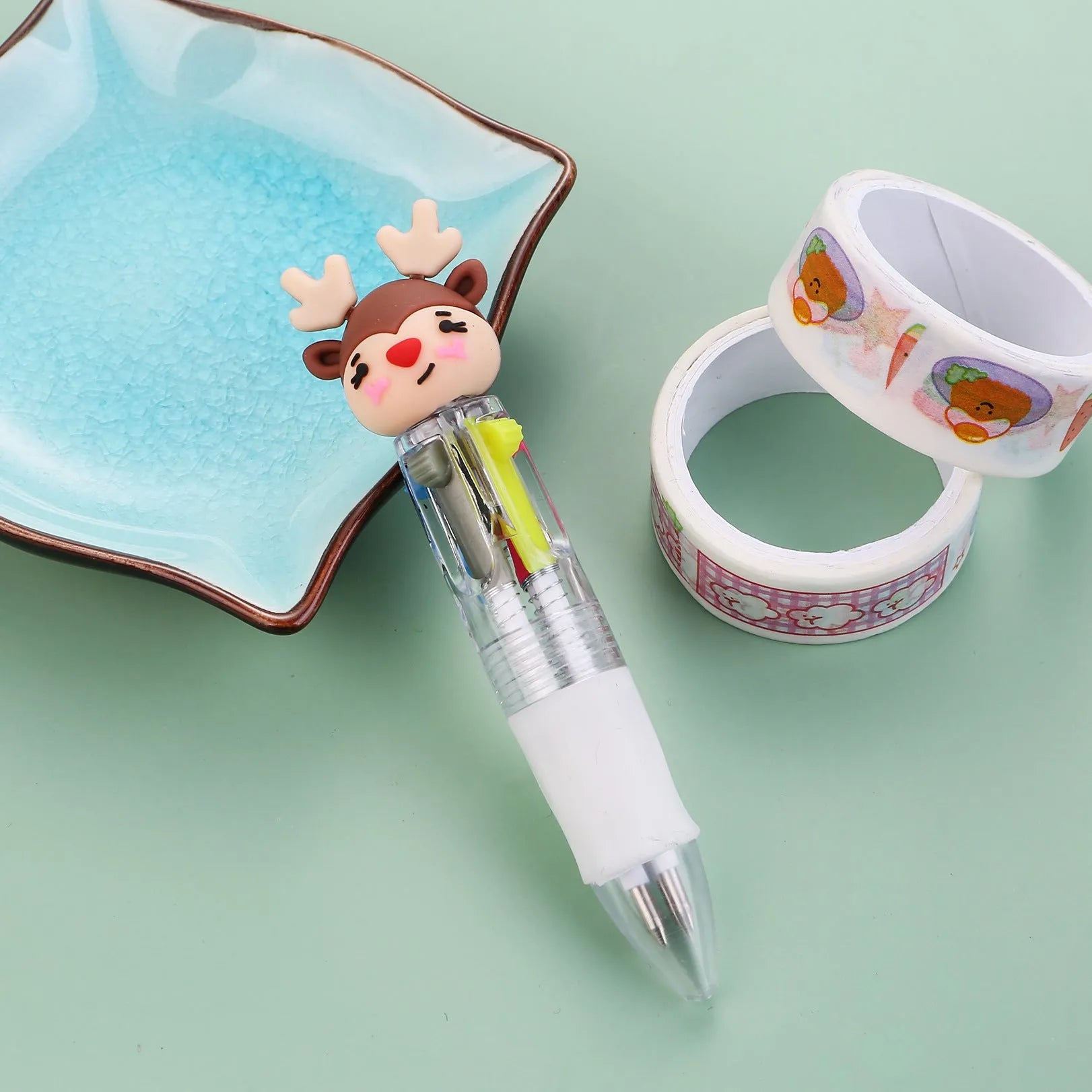 Compact 11cm Christmas four-colour press pen with festive designs including reindeer and snowmen.