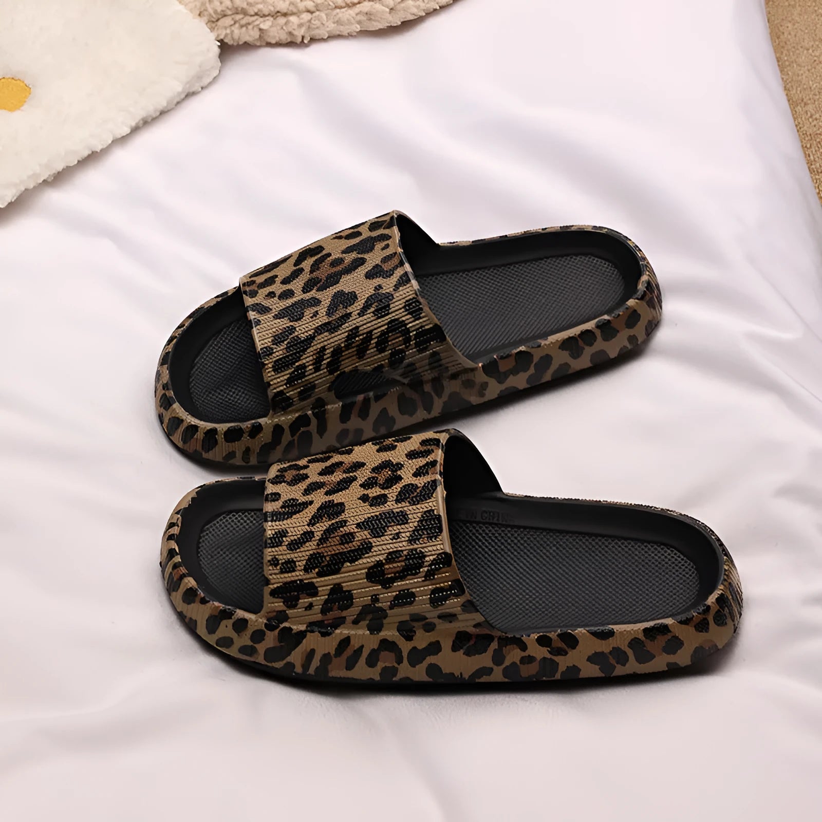 Women's leopard print EVA slippers with a thick sole on a plain background.