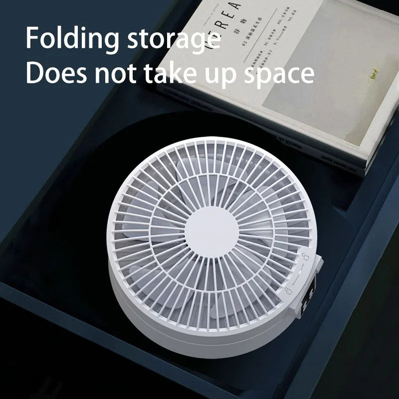 White USB rechargeable folding fan with remote control on a desk, showing 90° adjustable head and night light