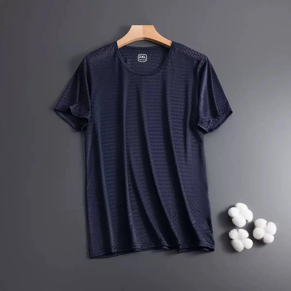 Man wearing a loose-fit ice silk short sleeve T-shirt in a solid colour.