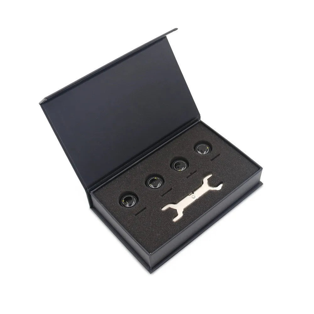 Black Bluetooth tyre pressure monitoring system kit with four external sensors, a wrench, and anti-theft screws on a white background