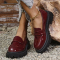Plus size black slip-on loafers with a chunky platform heel and thick rubber sole.