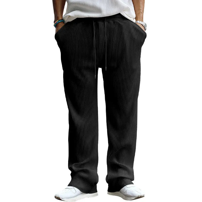 Man wearing army green striped high-waist straight-leg casual trousers.