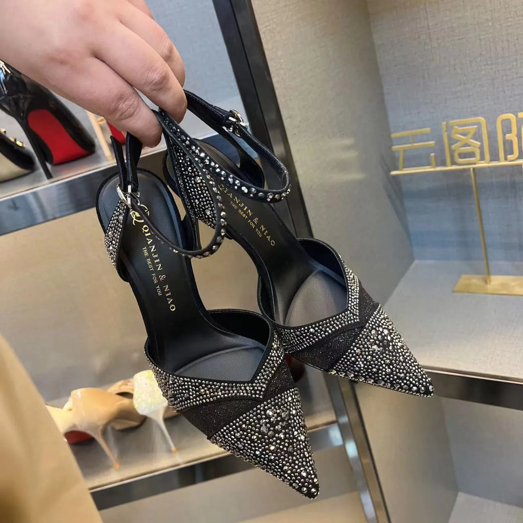 Women's silver and black stiletto heels with red sole and hollow design, pointed toe formal shoes