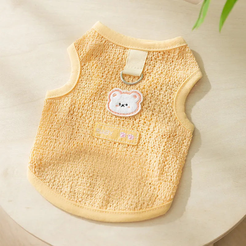 Green knitted cat clothing with a bear patch, showing hollowed-out breathable knit fabric.