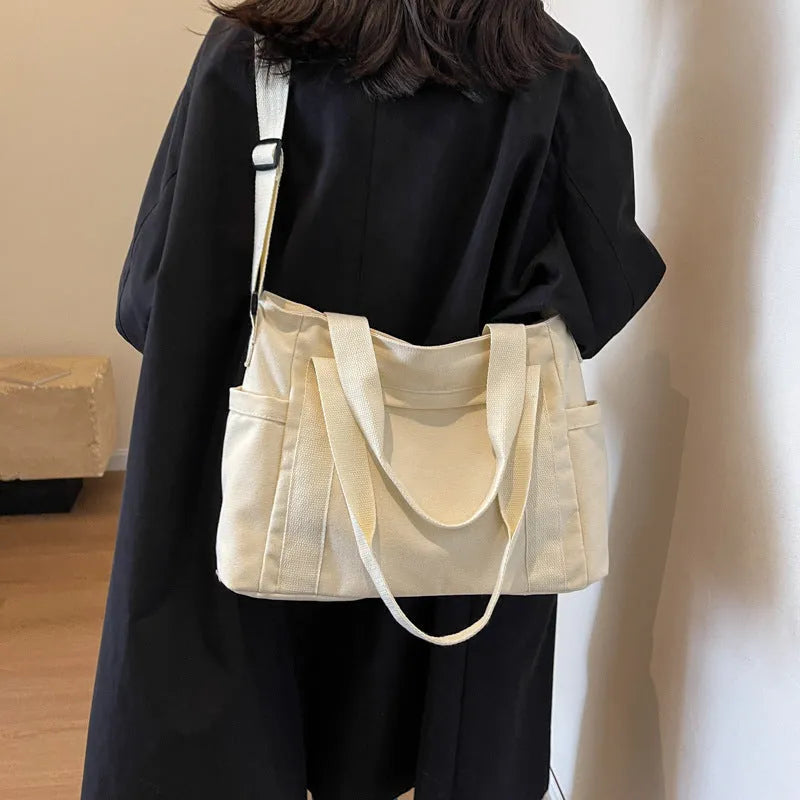 Women's canvas-style polyester shoulder bag with sandwich pocket and phone compartment in solid colour