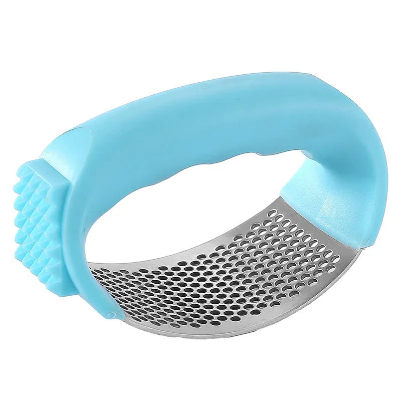Stainless steel garlic press in green, showing compact 11cm design for crushing garlic.