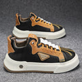 Men's beige low-top casual sneakers with elastic band and round toe, showing leather stitching detail.