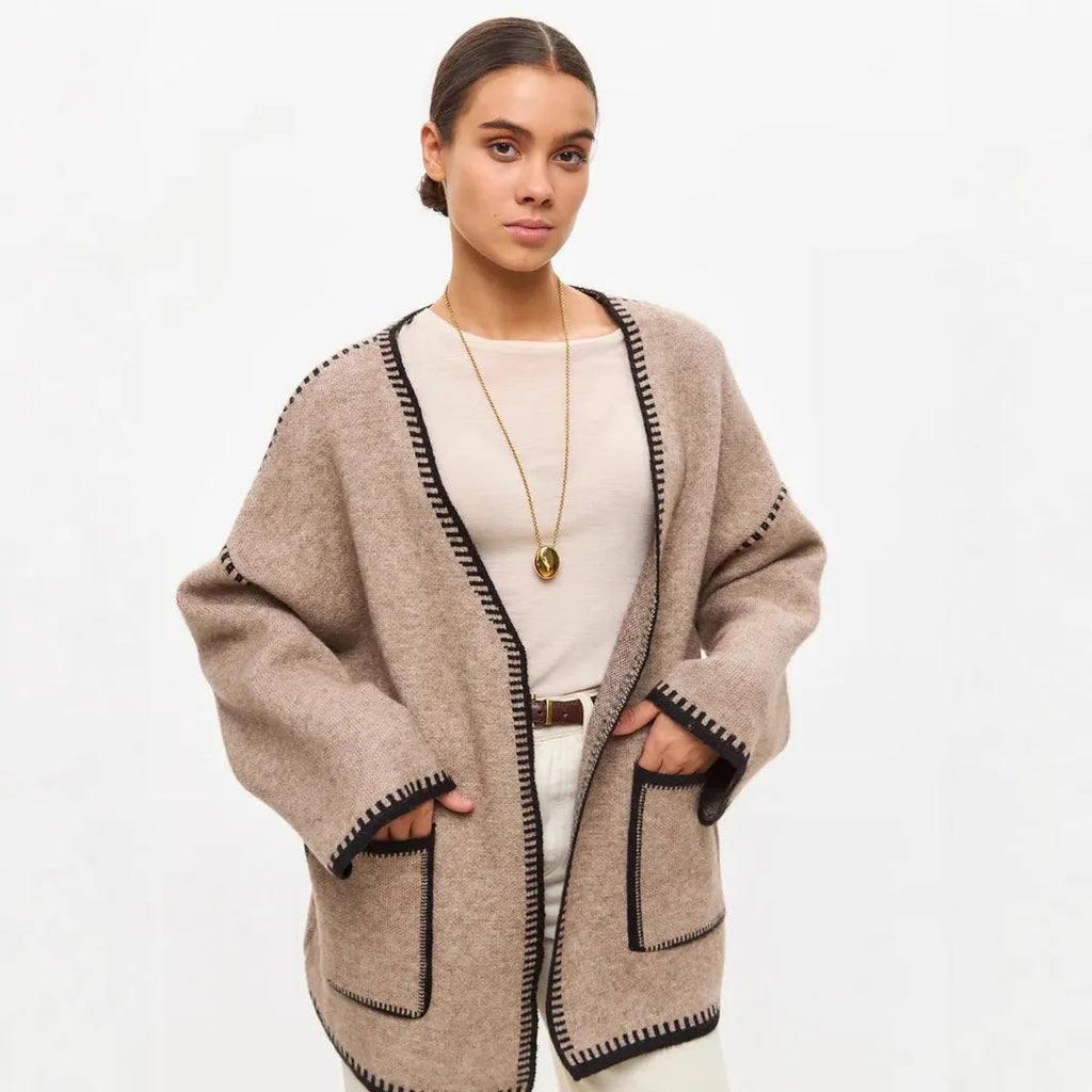 Loose fit knitted cardigan sweater coat in camel colour, showing long sleeves and mid-length hem.