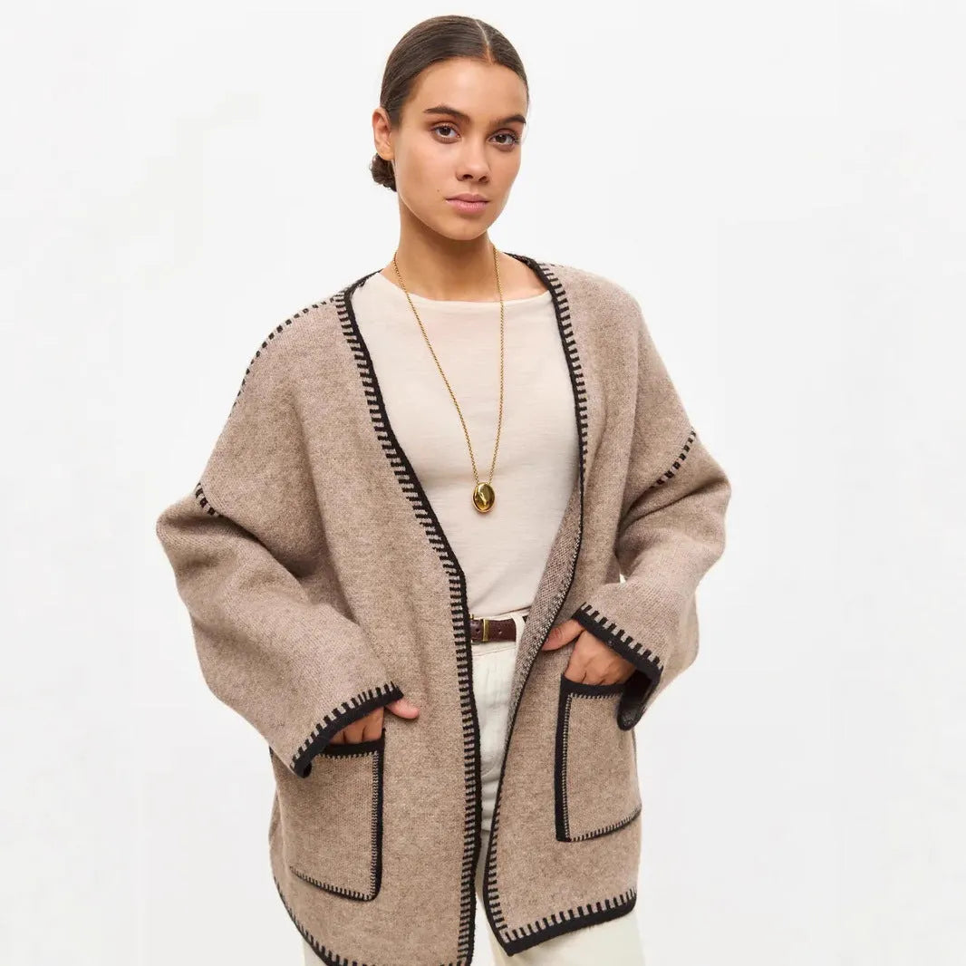 Loose fit knitted cardigan sweater coat in camel colour, showing long sleeves and mid-length hem.