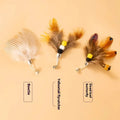 Three steel wire cat toy replacement heads with flying insects design on a plain background